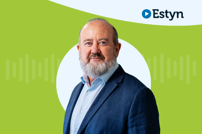 A portrait of a professional individual with the Estyn logo on the upper right, set against a dual-tone background of green and white.