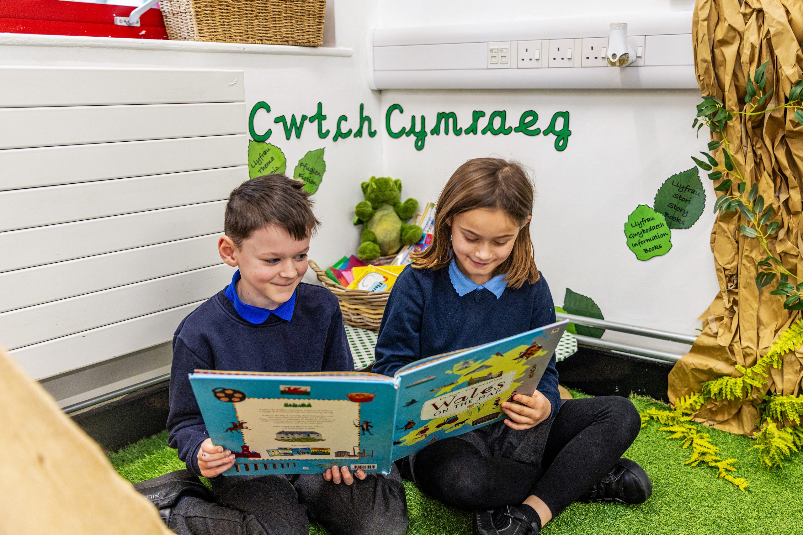 Estyn logo on blue background